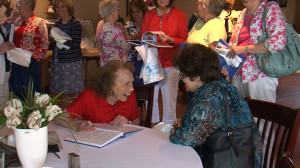 Author Marjorie Johnson Signing a Book