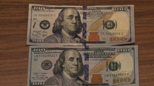 Counterfeit and Real 100 Dollar Bills
