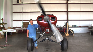 Airplane in Hangar with Propeller Spinning
