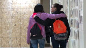 Two Student Girls Walking Together at School